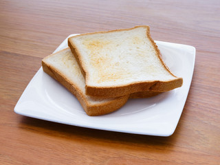 A pair of toasts in a plate on a table
