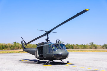 Military helicopter (huey) at a base
