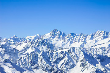Fototapeta na wymiar Panorama of Snow Mountain Range Blue Sky from Titlis Peak, Swit