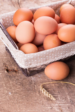 Eggs in bucket on wooden background