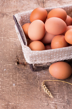 Eggs in bucket on wooden background