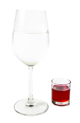 wine glass and red in small glass isolated