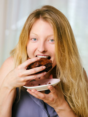 Female eating a brownie - 54855549