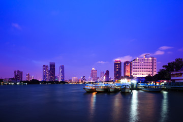 Chao phraya river at twilight with boats