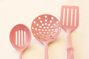 Kitchen cooking utensils. plastic spatulas in yellow cup