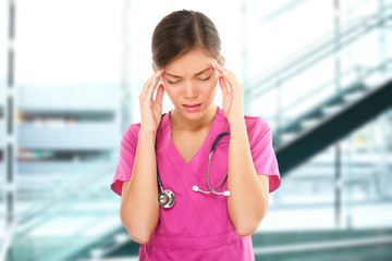 Stressed nurse medical professional with headache