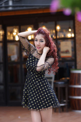 Fototapeta premium Beautiful young woman stand alone at the outdoor mall
