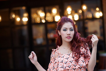 Beautiful young woman stand alone at the outdoor mall