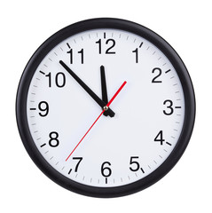 At five to twelve o'clock on the dial clock