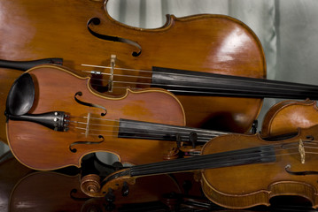 Two Violins, Viola and Cello on Piano on Curtain Background