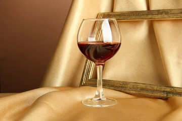 composition of frame and wine on bright background