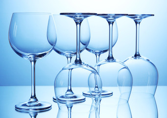 Empty wine glasses arranged on blue background
