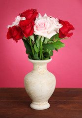 Beautiful bouquet of roses in vase with gift