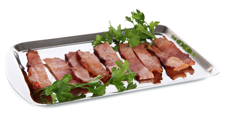 Fried bacon on metal tray isolated on white
