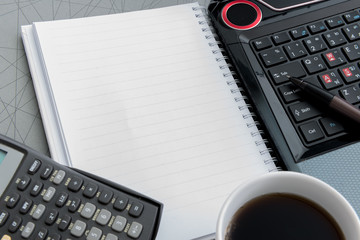 Coffee cup, laptop, Document file , pen , Calculator , notepad a