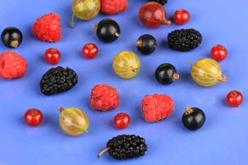 Ripe berries on blue background