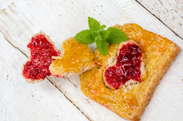 Heart-shaped bread with apricot and raspberry jam