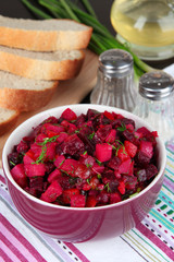 Beet salad in bowl on table close-up