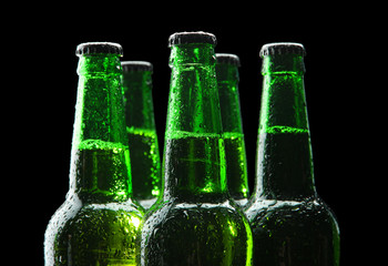 Bottles of beer on black background