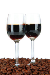 Glasses of liquor and coffee grains, isolated on white