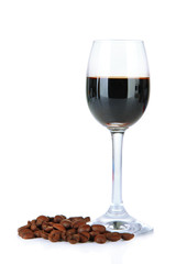 Glass of liquor and coffee grains, isolated on white