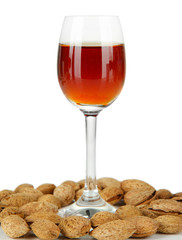 Glass of amaretto liquor and roasted almonds, isolated on white