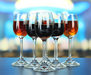 Glasses of liquors, on bright background