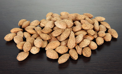 Almond on dark wooden background