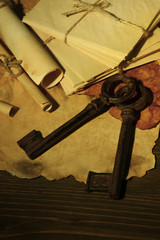 Antique keys and scroll on dark background