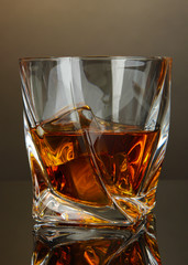 Glass of whiskey, on dark background