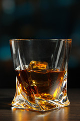Glass of whiskey, on dark background