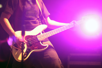 Fototapeta na wymiar Guitarist in nightclub, blur in moving