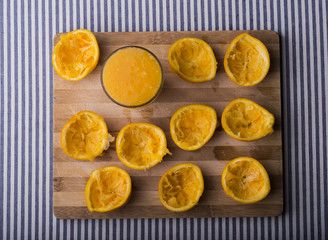 Squeezed oranges with glass of juice