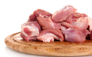 Pieces of raw meat on wooden board isolated on white