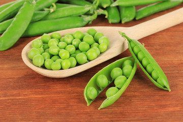 Sweet green peas on wooden background