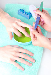 Man doing manicure in salon