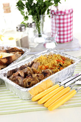 Food in boxes of foil on tablecloth