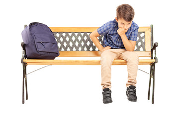 School boy sitting on a bench and thinking - Powered by Adobe