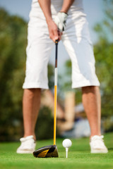 close up shot of golfer ready to tee off