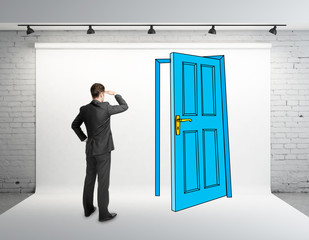 Fototapeta premium businessman looking at drawing door