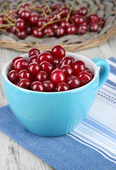 Sweet cherry in cup on table close-up