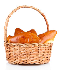 Fresh baked pasties in wicker basket, isolated on white