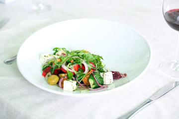 Greek salad on white plate, close up