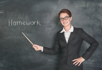 Smiling teacher with pointer and phrase Homework