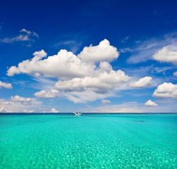 turquoise sea water and cloudy blue sky. paradise island