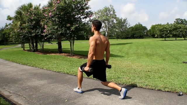 HD: man stretching outdoors - lunge. back view.