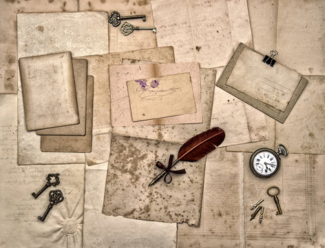old letters and photos, vintage keys, antique clock, feather pen