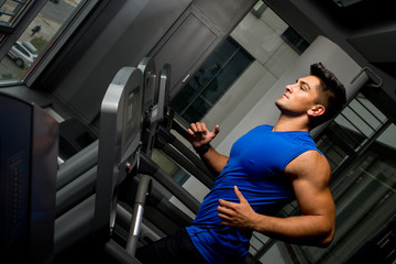 Fototapeta na wymiar Running on treadmill in gym