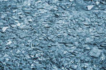 Water and pebbles. Blue toned image.