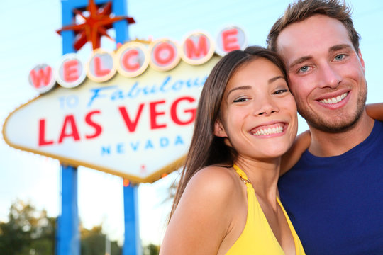 Las Vegas tourist couple at Las Vegas sign